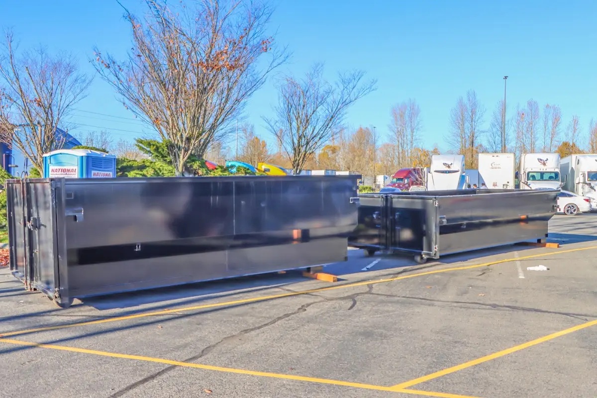 Professional dumpster rental service with roll-off container on residential driveway in Brookside